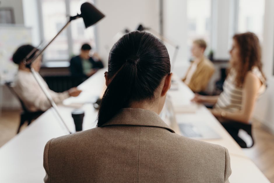 Team of focused professionals working collaboratively around a bright office table